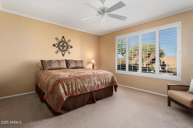 carpeted bedroom featuring ceiling fan and crown molding