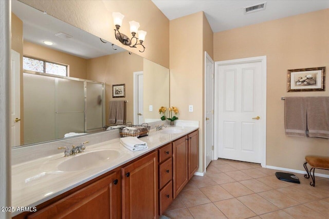 bathroom with tile patterned floors, vanity, walk in shower, and an inviting chandelier