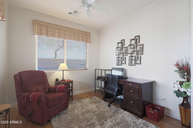 office with ceiling fan, wood-type flooring, and ornamental molding