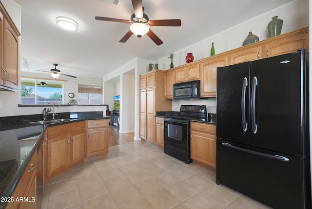 kitchen featuring light tile patterned floors, sink, dark stone countertops, and black appliances