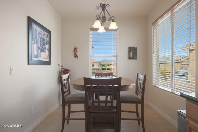 dining area featuring a chandelier and light tile patterned floors