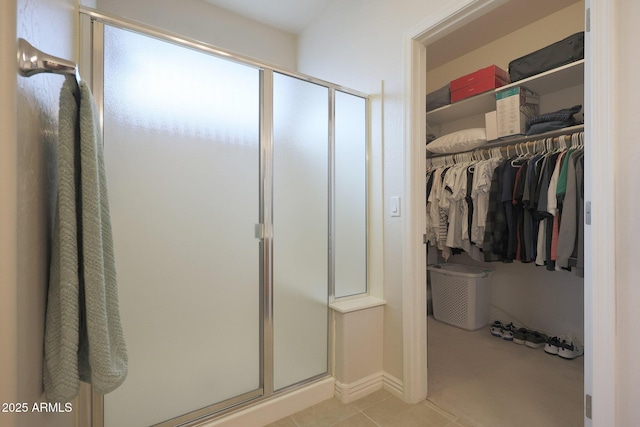 bathroom with tile patterned floors and a shower with shower door