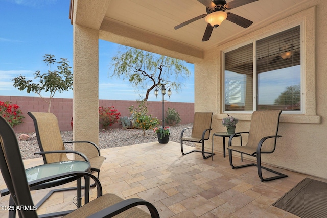 view of patio featuring ceiling fan