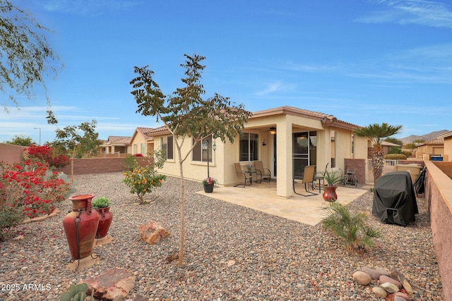 back of property featuring a patio area