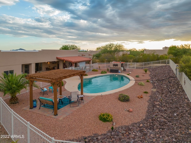 pool at dusk featuring a patio