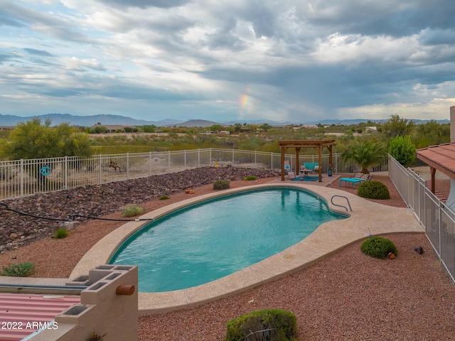 view of swimming pool with a mountain view and a patio