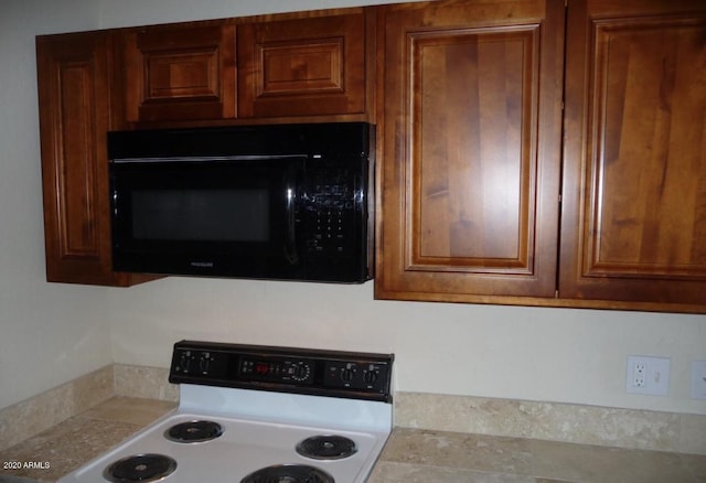 kitchen featuring white electric stove