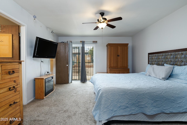 carpeted bedroom with access to exterior and a ceiling fan