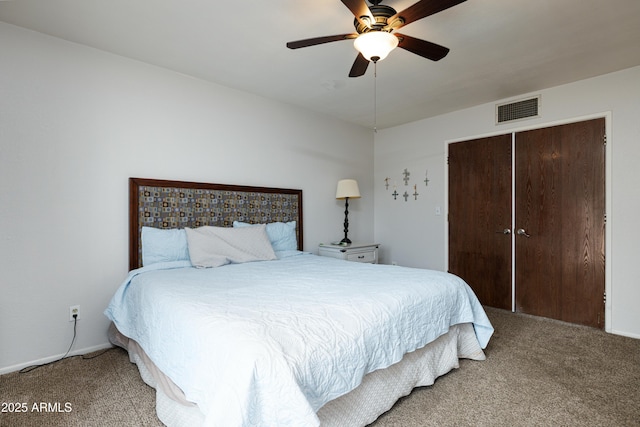 bedroom featuring ceiling fan, a closet, visible vents, and carpet flooring