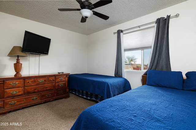 carpeted bedroom with a ceiling fan and a textured ceiling