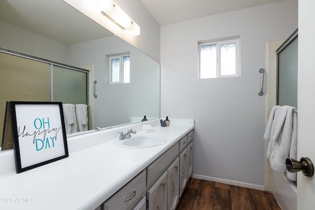 bathroom with a shower with door, vanity, a wealth of natural light, and wood finished floors