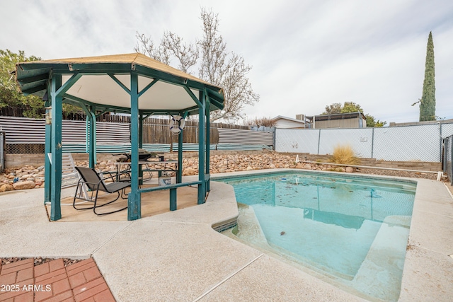 view of pool with a gazebo, a patio, and a fenced backyard