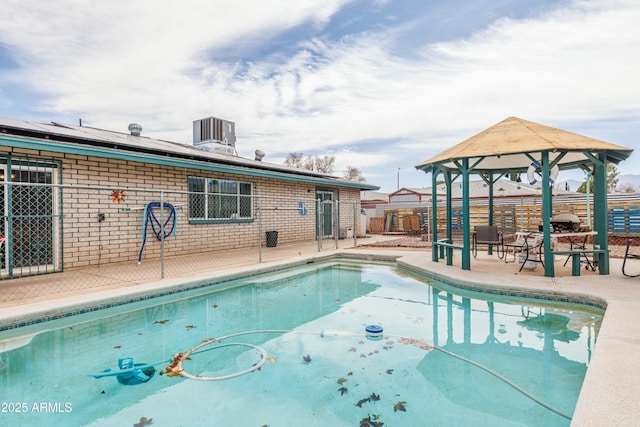 view of pool featuring central air condition unit, fence, a gazebo, a fenced in pool, and a patio area