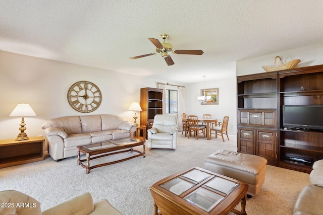 living area with carpet floors, a ceiling fan, and a textured ceiling