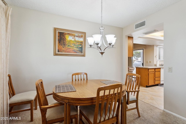 dining space featuring baseboards, a notable chandelier, light colored carpet, and visible vents