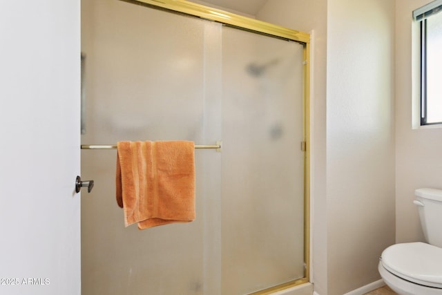 full bath with a stall shower and toilet