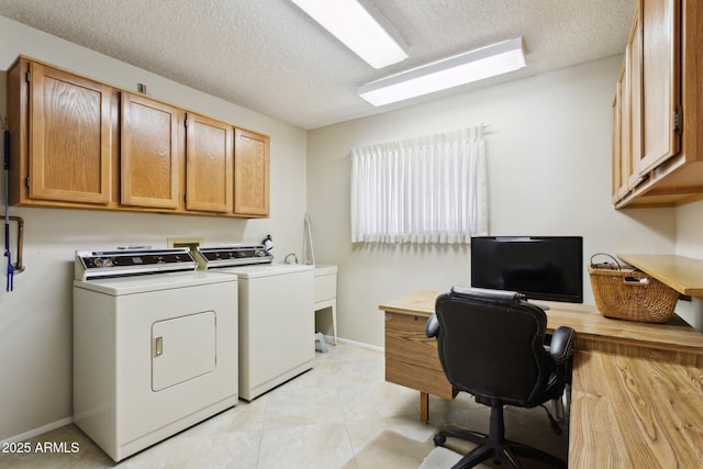 laundry room featuring baseboards, a textured ceiling, independent washer and dryer, and cabinet space