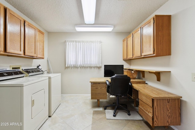 office space with baseboards, a textured ceiling, light tile patterned floors, and washer and dryer