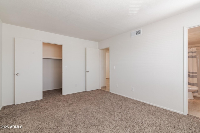 925 S Longmore Unit 201, Mesa, AZ 85202 - unfurnished bedroom with light colored carpet, ensuite bath, a spacious closet, and a closet