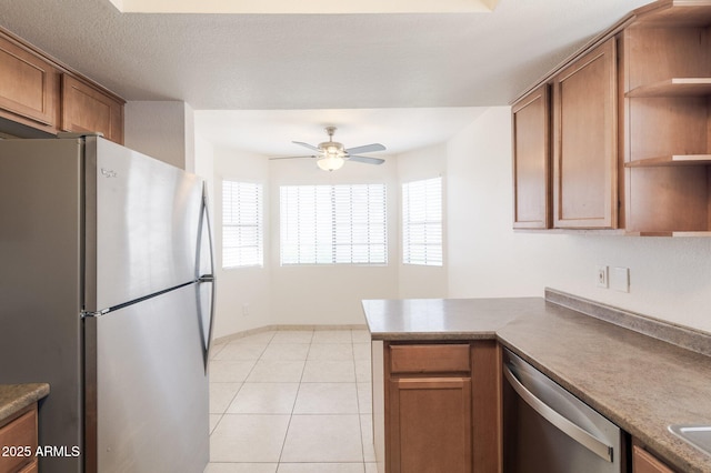 925 S Longmore Unit 201, Mesa, AZ 85202 - kitchen with appliances with stainless steel finishes, open shelves, ceiling fan, brown cabinets, and a peninsula