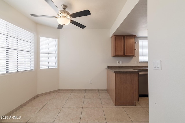 925 S Longmore Unit 201, Mesa, AZ 85202 - kitchen featuring dark countertops, ceiling fan, brown cabinets, open shelves, and light tile patterned floors