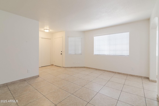925 S Longmore Unit 201, Mesa, AZ 85202 - spare room featuring light tile patterned flooring and baseboards