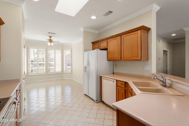 kitchen featuring sink, white appliances, a skylight, ornamental molding, and ceiling fan