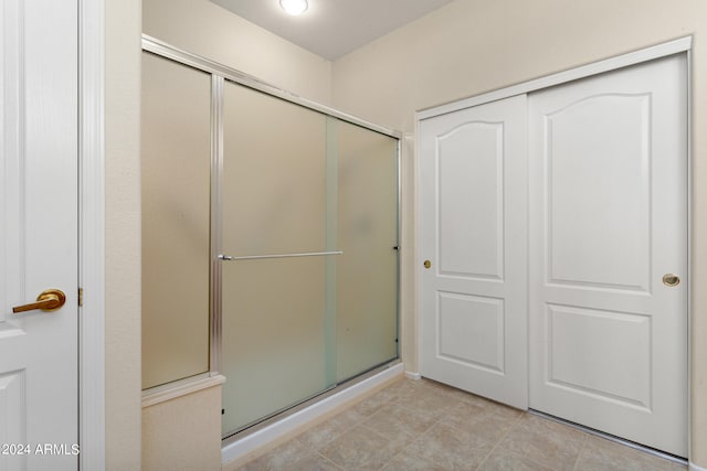 bathroom with tile patterned flooring and an enclosed shower