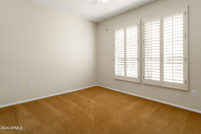 spare room with carpet flooring and ceiling fan