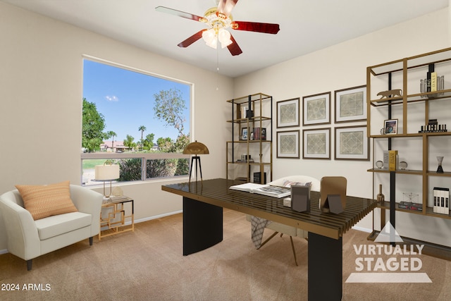 carpeted home office featuring ceiling fan