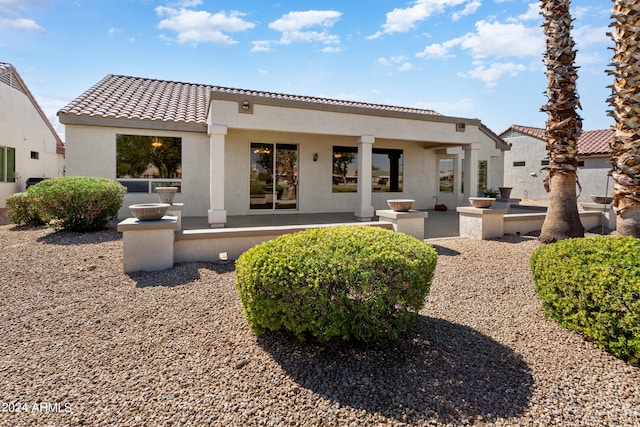 back of property with a patio