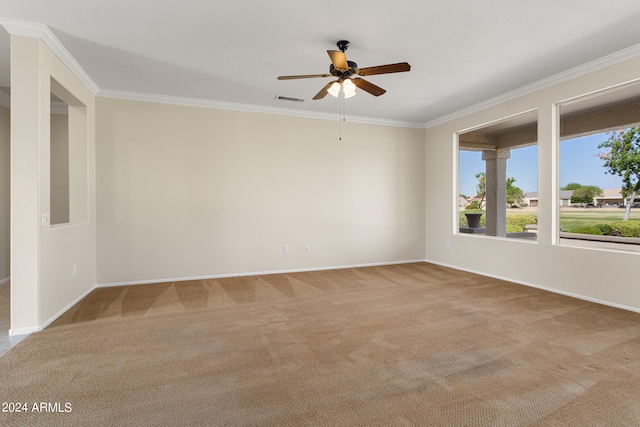 carpeted empty room with ceiling fan and crown molding