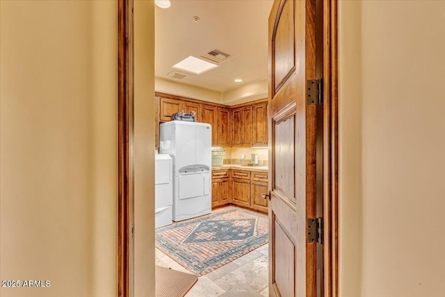 kitchen with white refrigerator and washing machine and clothes dryer