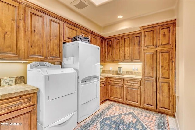 laundry room with cabinets and separate washer and dryer