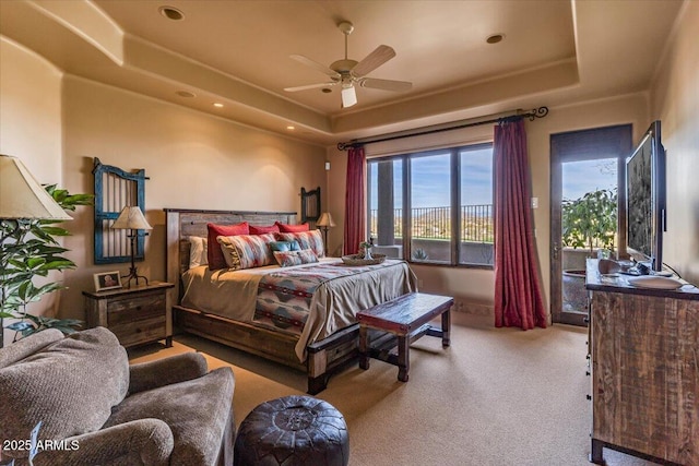 bedroom featuring access to exterior, a tray ceiling, and light carpet