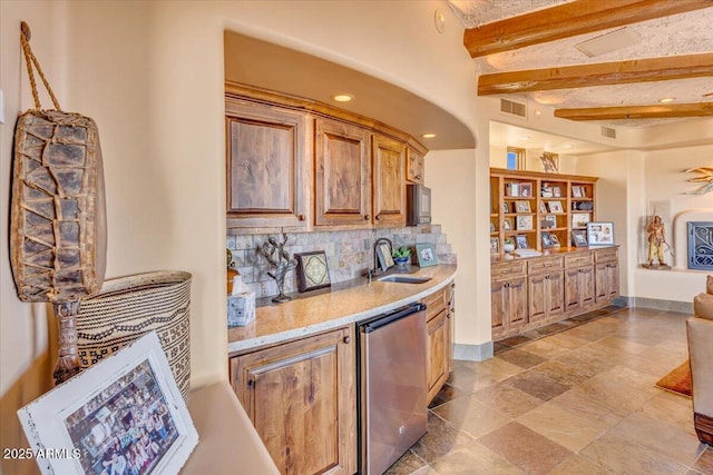 bar featuring beamed ceiling, dishwasher, sink, backsplash, and hanging light fixtures