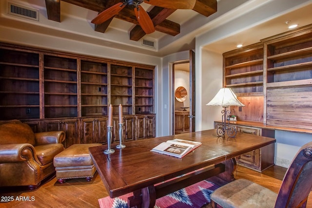 office area with ceiling fan, coffered ceiling, beam ceiling, and light hardwood / wood-style flooring