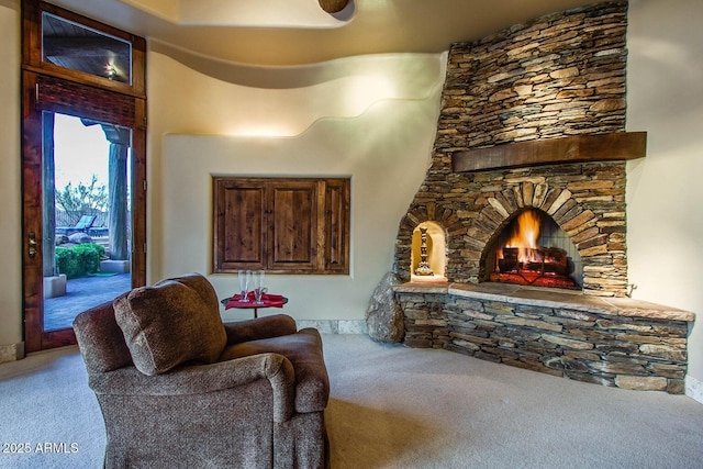 living room featuring a fireplace and carpet flooring