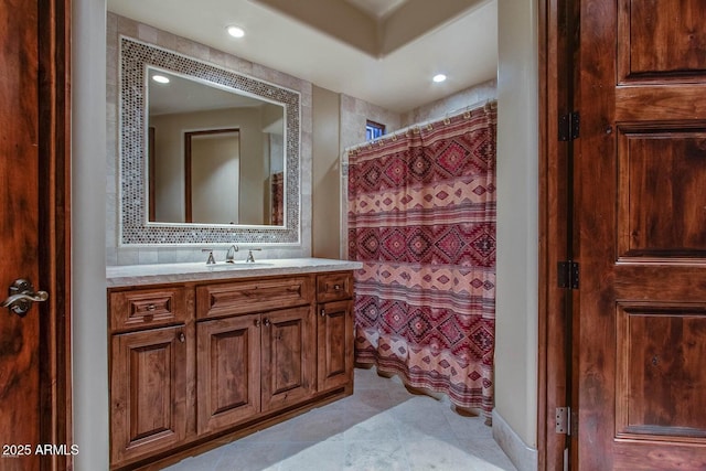 bathroom featuring walk in shower, tile patterned floors, vanity, and backsplash