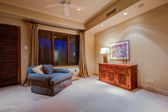 sitting room featuring ceiling fan and light carpet