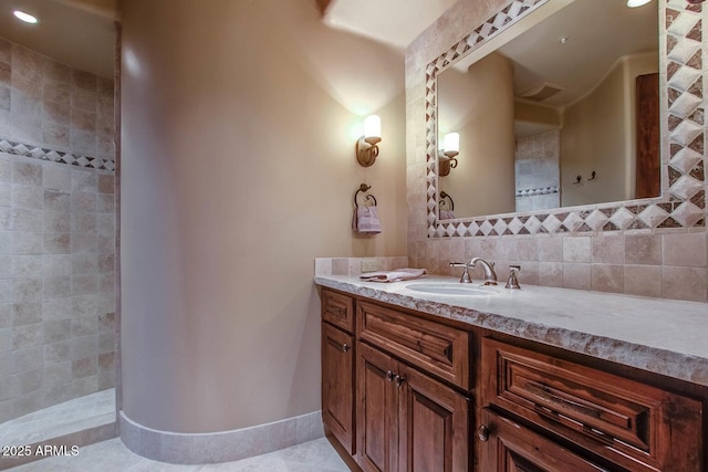 bathroom with vanity, tile patterned flooring, and tasteful backsplash