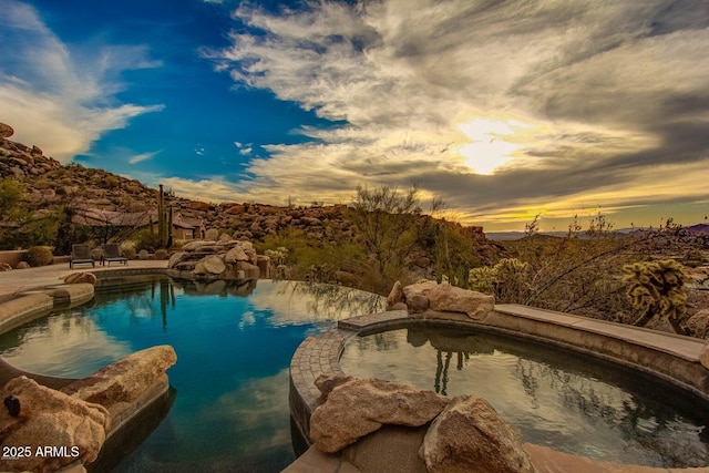 view of pool at dusk