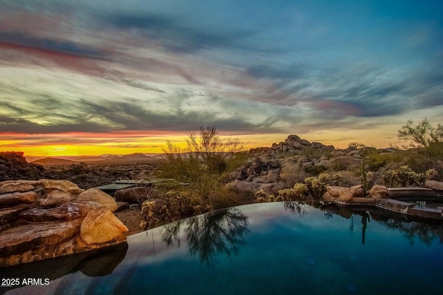 view of pool at dusk