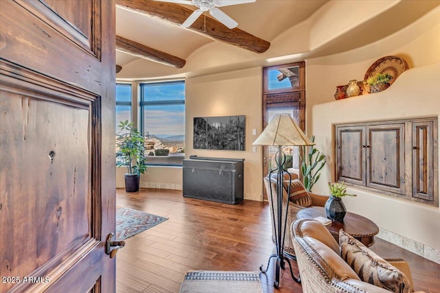 interior space featuring lofted ceiling with beams, hardwood / wood-style floors, and ceiling fan