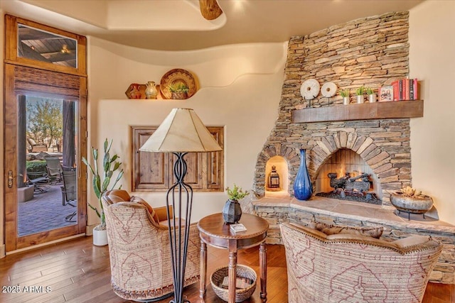 living area featuring a fireplace and dark wood-type flooring