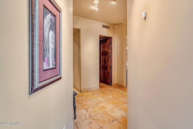 hall featuring light tile patterned floors