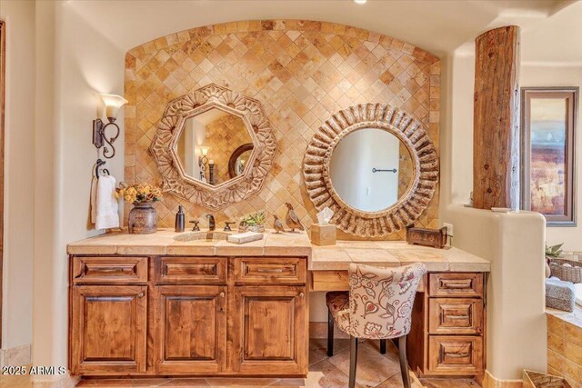 bathroom featuring vanity and backsplash