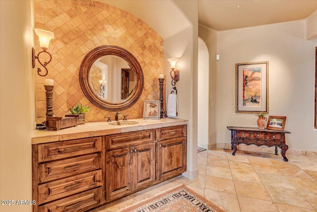 bathroom with tasteful backsplash, vanity, and tile patterned floors