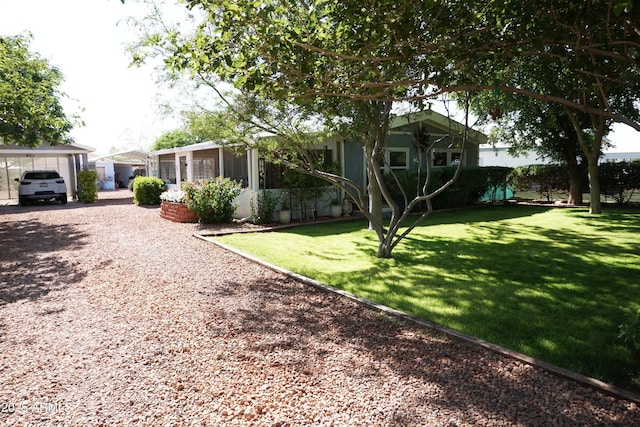1034 S 3rd St, Coolidge, AZ 85128 - view of grassy yard featuring a sunroom and driveway