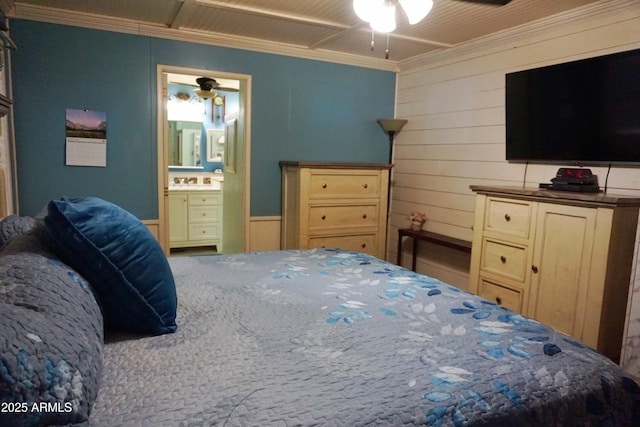 1034 S 3rd St, Coolidge, AZ 85128 - bedroom with ornamental molding, connected bathroom, wooden walls, and ceiling fan